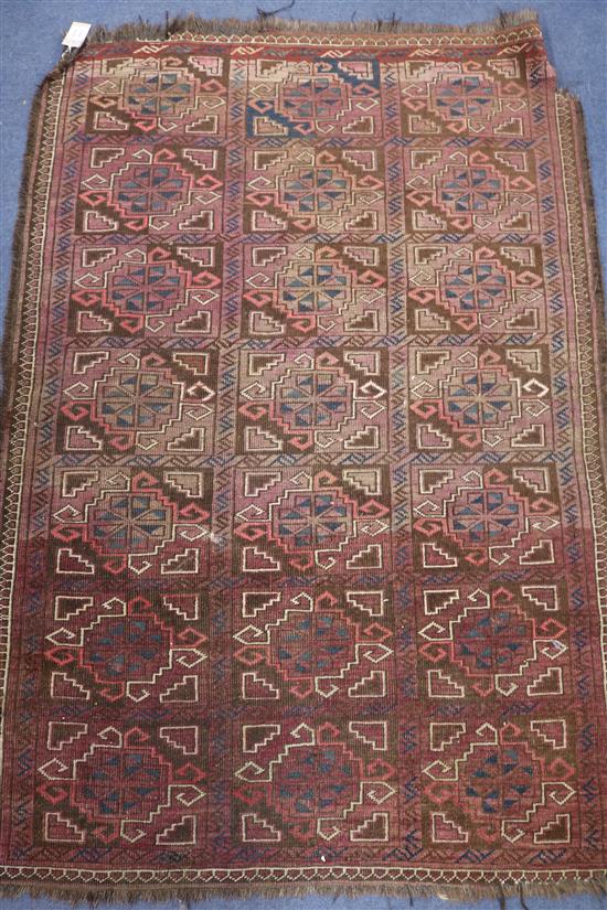 An Afghan red ground geometric patterned rug 145 x 102cm